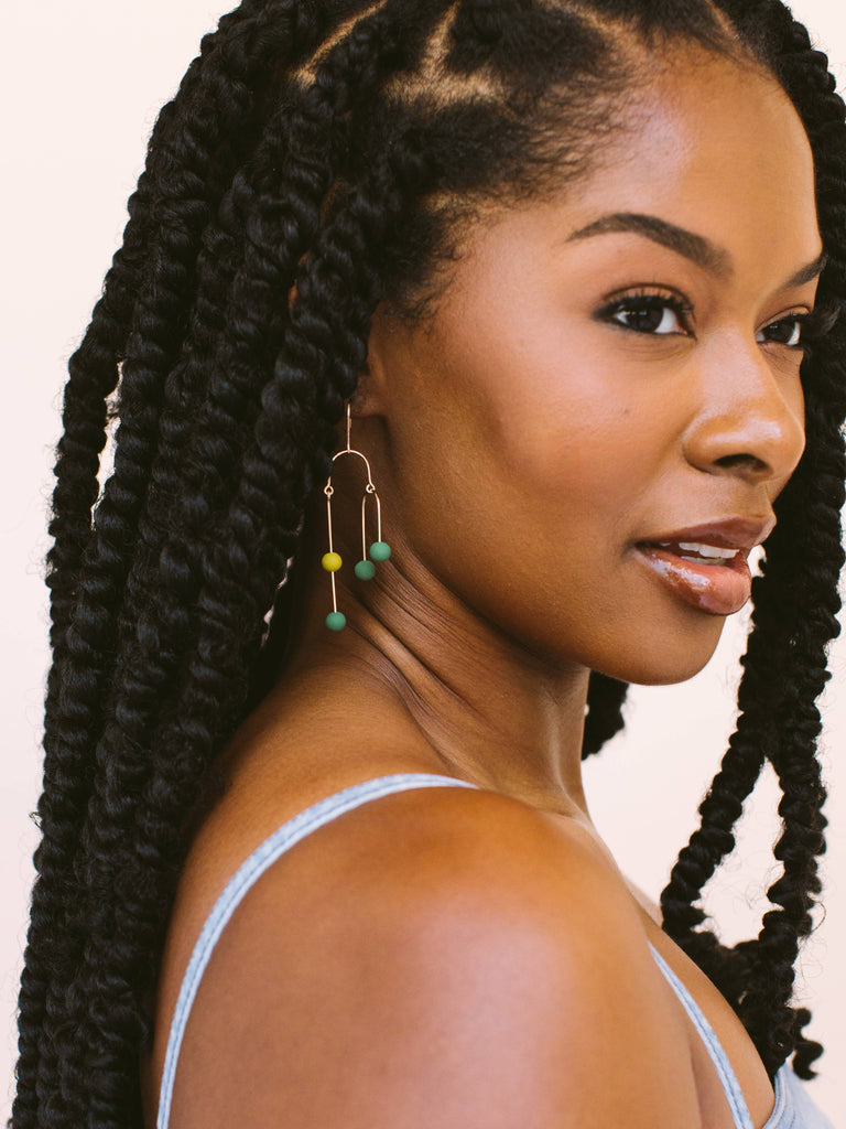 Emerald (green) and sundance (golden) earrings come in gold and silver and are handmade locally in Charlotte, NC (North Carolina), at a Plaza Midwood woman owned jewelry art and home decor gift shop. A can't miss thing to do - order a housemade vegan chai at The Chai Window to sip while you shop. 