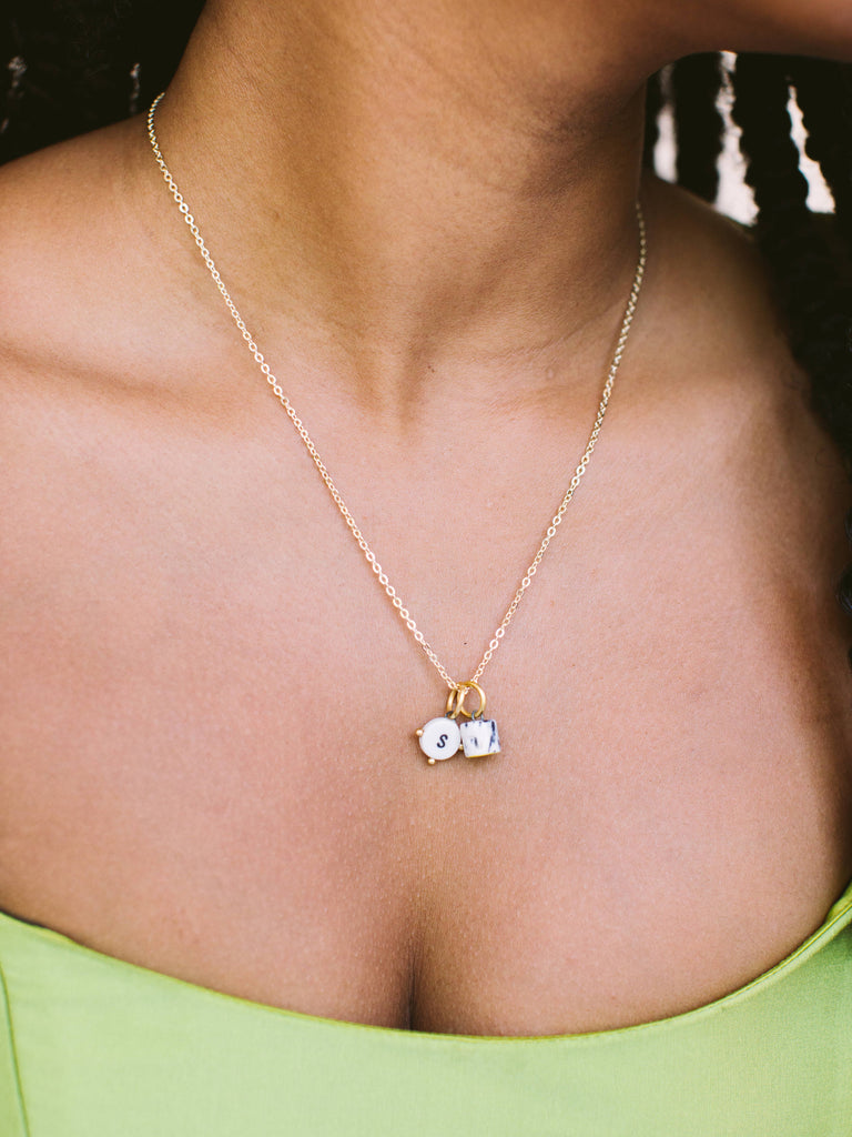 Charm necklace base with two charms shown, handmade locally in Charlotte, NC (North Carolina), at a Plaza Midwood woman owned jewelry art and home decor gift shop. Book our bracelet bar, it's great for your bridal or baby shower, and bachelor/bachelorette parties. A can't miss thing to do - order a housemade vegan chai at The Chai Window to sip while you shop. 