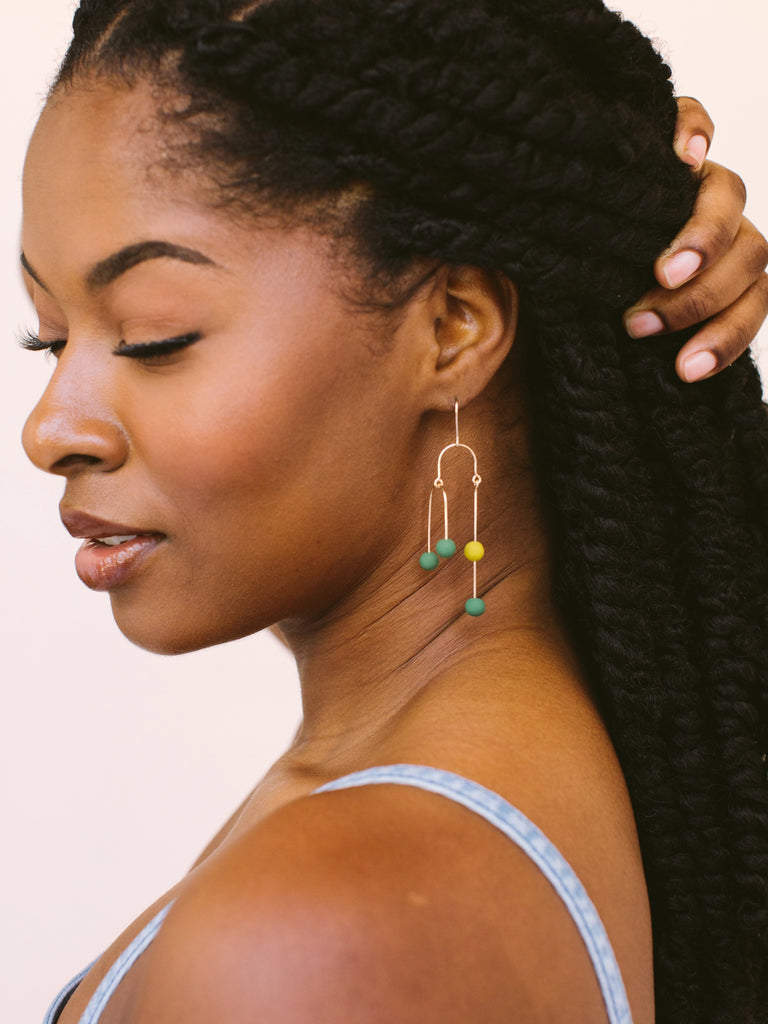 Emerald (green) and sundance (golden) earrings come in gold and silver and are handmade locally in Charlotte, NC (North Carolina), at a Plaza Midwood woman owned jewelry art and home decor gift shop. A can't miss thing to do - order a housemade vegan chai at The Chai Window to sip while you shop. 