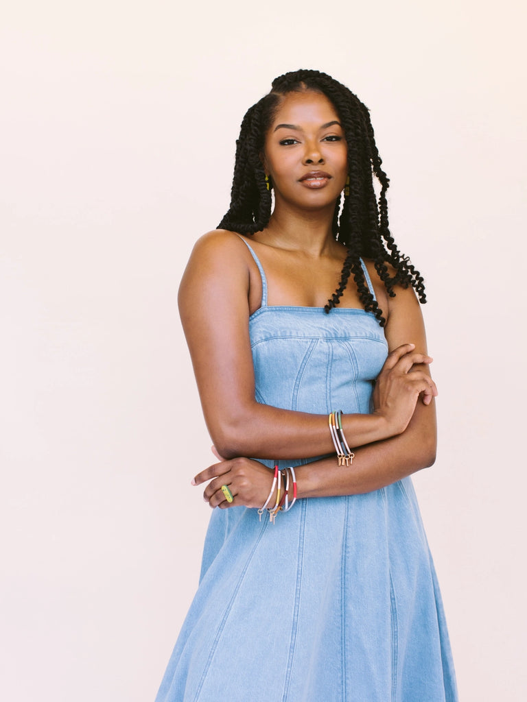 Woman modeling two tone bangles, handmade locally in Charlotte, NC (North Carolina), at a Plaza Midwood woman owned jewelry art and home decor gift shop. A can't miss thing to do - order a housemade vegan chai at The Chai Window to sip while you shop. 