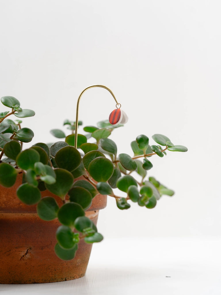 Potted plant with plant butterfly, handmade locally in Charlotte, NC (North Carolina), at a Plaza Midwood woman owned jewelry art and home decor gift shop. A can't miss thing to do - order a housemade vegan chai at The Chai Window to sip while you shop. 