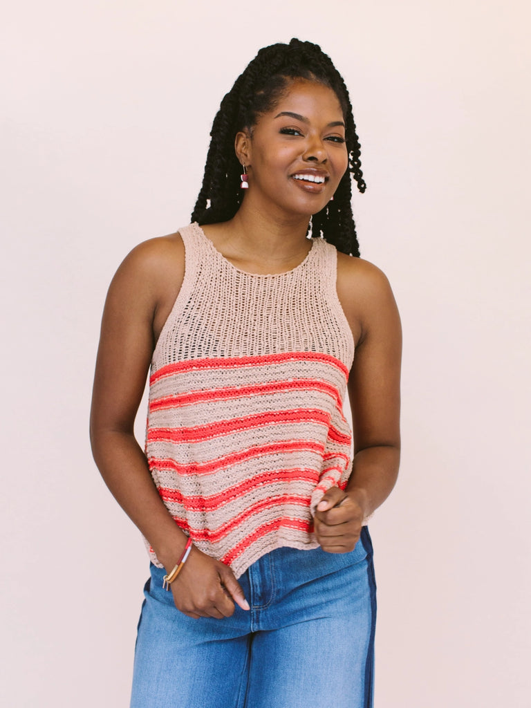 Woman wearing colorblock bangle bracelets, handmade locally in Charlotte, NC (North Carolina), at a Plaza Midwood woman owned jewelry art and home decor gift shop. A can't miss thing to do - order a housemade vegan chai at The Chai Window to sip while you shop. 
