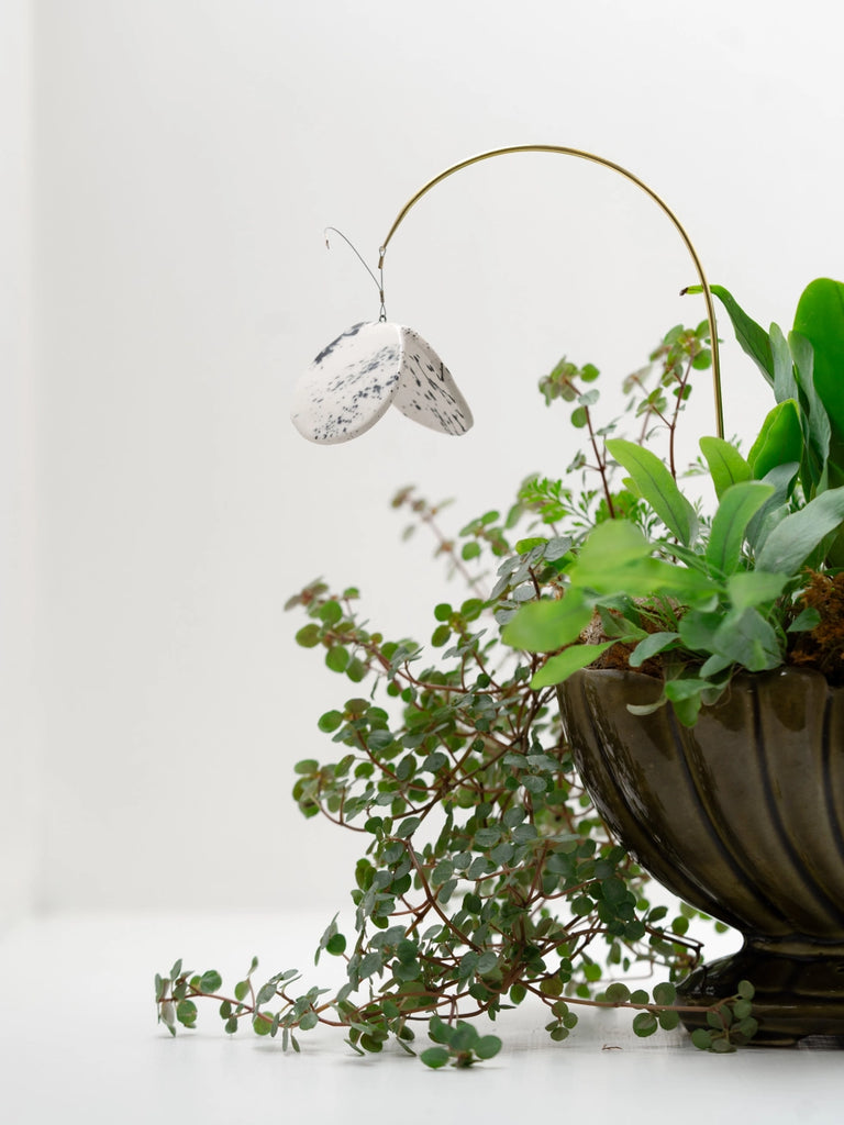 Potted plant charm, handmade locally in Charlotte, NC (North Carolina), at a Plaza Midwood woman owned jewelry art and home decor gift shop. A can't miss thing to do - order a housemade vegan chai at The Chai Window to sip while you shop. 