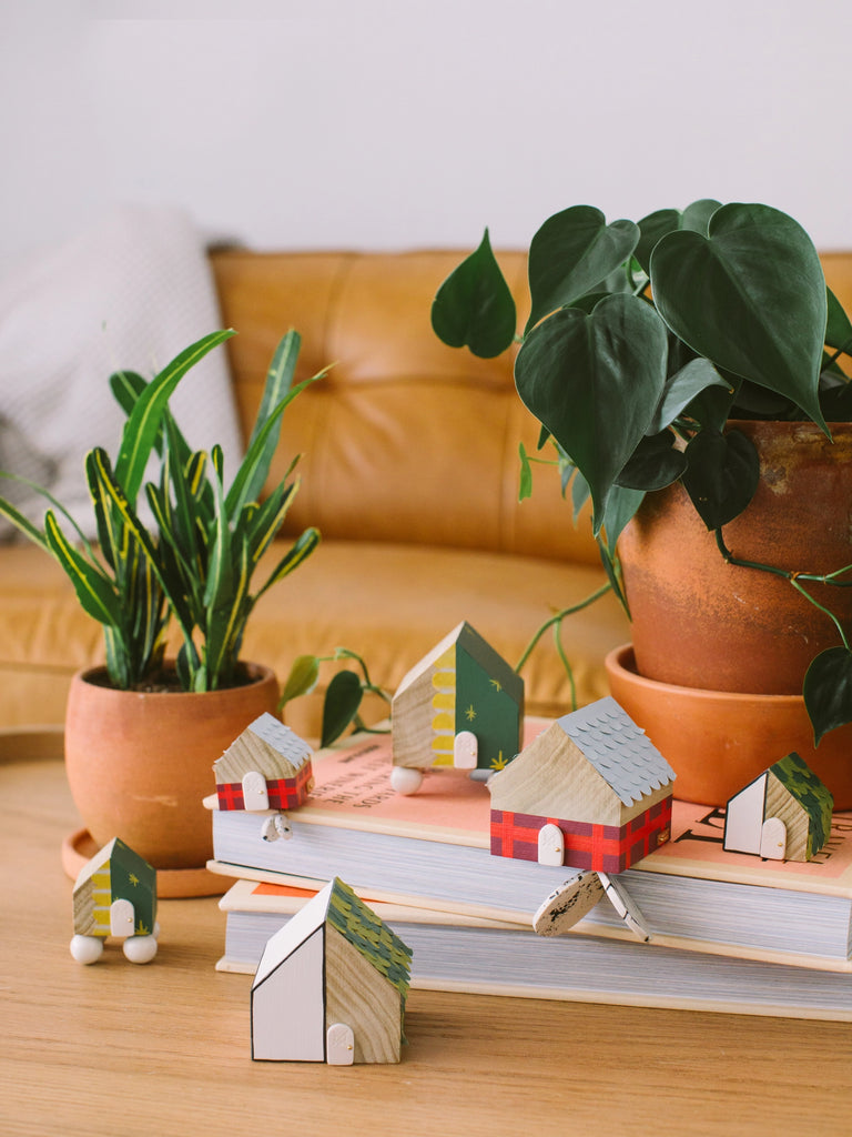 Small wooden houses designed and created at home decor and jewelry store Twenty Two West. 