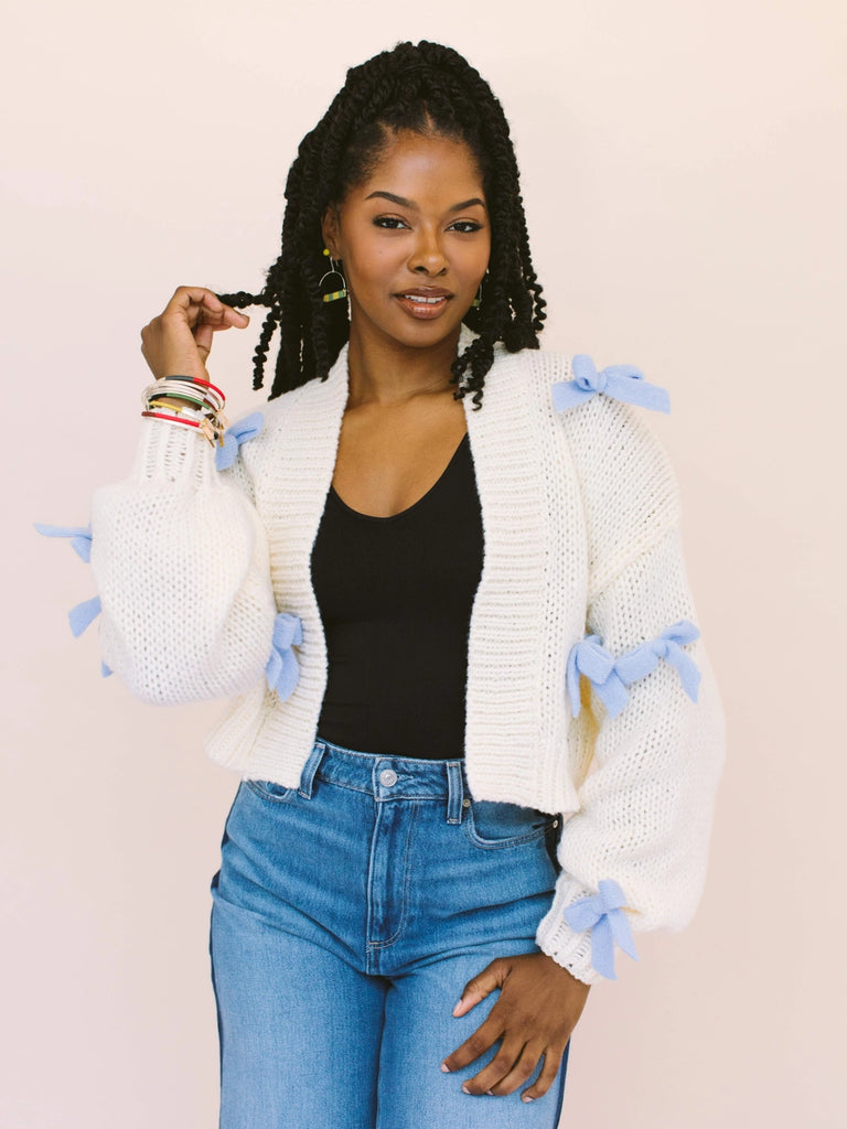 Woman wearing wrapped bangles that can be stacked/layered and worn together, handmade locally in Charlotte, NC (North Carolina), at a Plaza Midwood woman owned jewelry art and home decor gift shop. A can't miss thing to do - order a housemade vegan chai at The Chai Window to sip while you shop. 